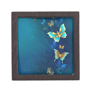 Goldene Schmetterlinge auf blauem Hintergrund Kiste
