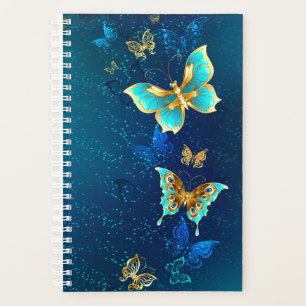 Goldene Schmetterlinge auf blauem Hintergrund Planer
