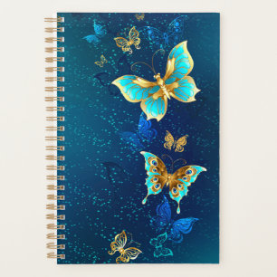 Goldene Schmetterlinge auf blauem Hintergrund Planer