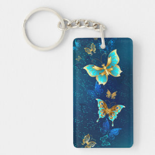 Goldene Schmetterlinge auf blauem Hintergrund Schlüsselanhänger