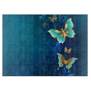 Goldene Schmetterlinge auf blauem Hintergrund Schneidebrett
