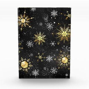 Goldene Schneeflocken auf schwarzem Hintergrund Fotoblock