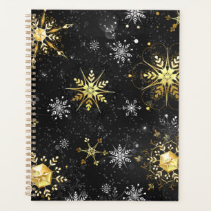 Goldene Schneeflocken auf schwarzem Hintergrund Planer