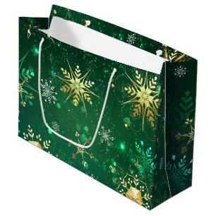Goldene Schneeflocken im grünen Hintergrund Große Geschenktüte