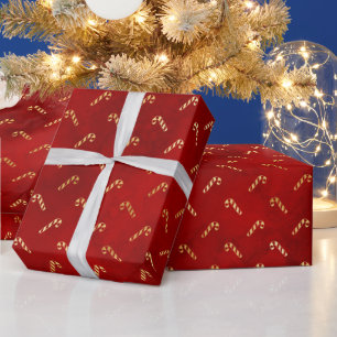 Goldene Weihnachtszuckerrohre auf Rot Geschenkpapier