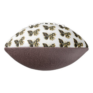 Goldener Schmetterling mit schwarzem Orchid Football