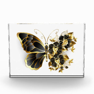 Goldener Schmetterling mit schwarzem Orchid Fotoblock