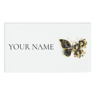 Goldener Schmetterling mit schwarzem Orchid Namenschild
