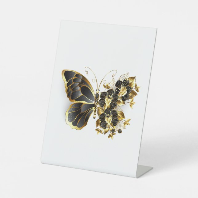 Goldener Schmetterling mit schwarzem Orchid Sockelschild (Vorderseite)