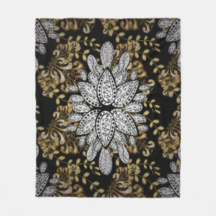 Goldenes Element auf schwarzem Hintergrund. Golden Fleecedecke