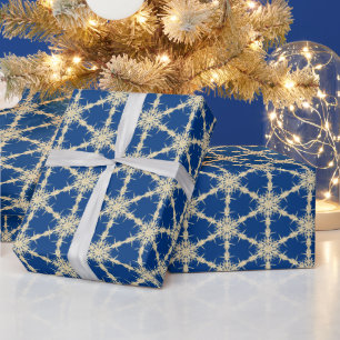 Goldschneeflocken auf blau geschenkpapier