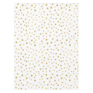 Goldsterne auf weißer Tischdecke
