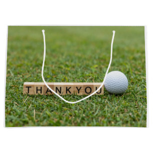 Golfball mit dem Text Danke auf grünem Gras Große Geschenktüte