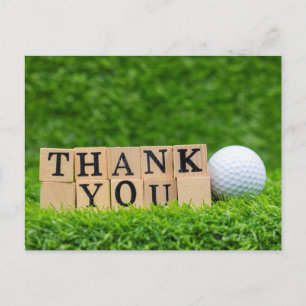 Golfball mit dem Wort Danke auf grünem Gras Postkarte
