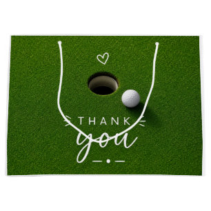 Golfball neben Loch auf grünem Gras Danke Große Geschenktüte