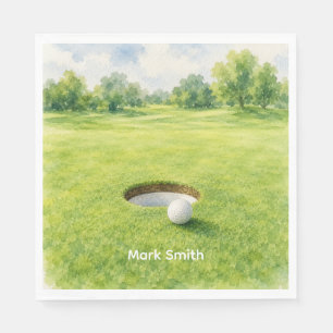 Golfball neben Loch auf grünem Putting-Rasen  Serviette