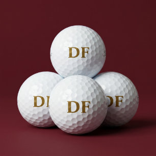 Golfbälle mit Gold-Monogramm