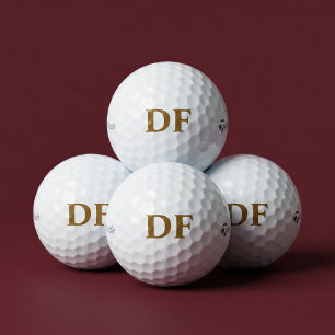 Golfbälle mit goldener Monogramm-Prägung