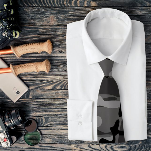 Grau und Schwarz Camouflage Necktie Krawatte (A gray camo necktie is featured on a shirt and a assemblage of outdoors related accessories.)