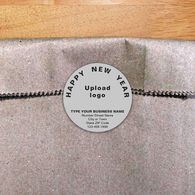 Graue Round-Sticker für das Geschäftsjahr Runder Aufkleber (New Year greeting with your business brand on gray round shape sticker.)