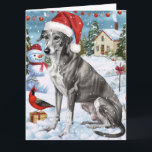Greyhound Winter Wonderland Christmas Joy Karte<br><div class="desc">Dieses festliche Design spiegelt den fröhlichen Geist der Urlaubssaison wider und besticht durch ein hübsches Jungtier mit einer Weihnachtsmannmütze. Der Hund ist eingebettet in ein winterliches Wunderland, mit einem Schneemann, einem dekorierten Weihnachtsbaum und wunderschön verpackten Geschenken. Schneeflocken fallen sanft ab und geben der Szene eine magische Touch, während die lebhaften...</div>