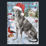 Greyhound Winter Wonderland Christmas Joy Notizblock<br><div class="desc">Dieses festliche Design spiegelt den fröhlichen Geist der Urlaubssaison wider und besticht durch ein hübsches Jungtier mit einer Weihnachtsmannmütze. Der Hund ist eingebettet in ein winterliches Wunderland, mit einem Schneemann, einem dekorierten Weihnachtsbaum und wunderschön verpackten Geschenken. Schneeflocken fallen sanft ab und geben der Szene eine magische Touch, während die lebhaften...</div>