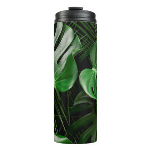 Grüne Monstera-Blätter und Blätter aus Palmen Thermosbecher