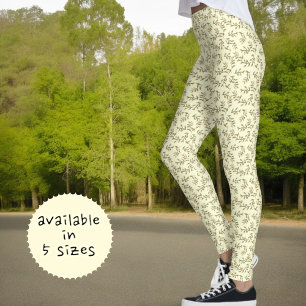 Grünes Blattmuster auf pastellgelbem Hintergrund Leggings