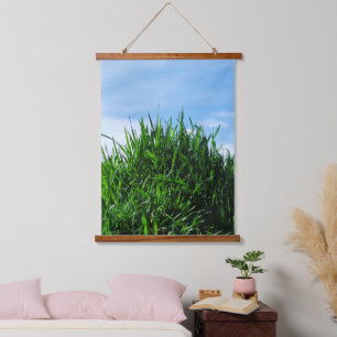 Grünes Gras vor dem Hintergrund des endlosen Wandteppich Mit Holzrahmen