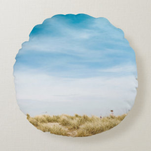 Grünes Grasfeld unter blauem Himmel Rundes Kissen