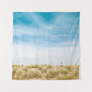 Grünes Grasfeld unter blauem Himmel Wandteppich