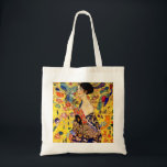 Gustav Klimt Lady mit Fan Tragetasche<br><div class="desc">Tote Bag Featuring Gustav Klimt’s oil painting Lady with Fan (1918). A woman wearing a blue kimono holds a red fan against a colorful yellow background of flowers and peacocks. A great gift for fans of Japans and European art.</div>