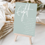 Handgezeichnete Tabelle ACHTUNG   Gast-Namen Tischnummer<br><div class="desc">Einfache und schicke Tischnummer-Karten in Sage Green und Weiß machen eine elegante Aussage bei Ihrer Hochzeit oder Veranstaltung. Das Design enthält "Table [number]" in einem spannenden Mix aus klassischer Serif und handgeschriebenem Skriptsatz, darunter einzelne Gastnamen. Design wiederholt sich auf beiden Seiten. Einzelne nummerierte Karten werden separat verkauft; bestellen Sie jede...</div>