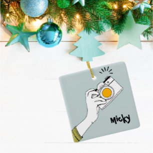 Handklick auf eine Kamera-Ornament im Cartoon Keramikornament