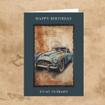 Happy Birthday Husband Vintage Car Gruß Karte<br><div class="desc">Alles Gute zum Geburtstag für ihn. Herzlichen Glückwunsch zum Geburtstag Zu meinem Mann grüßen über und unter einer Aquarell-Abbildung eines klassischen Vintage-Autos, Retro-Modell in verwitterter blauer Farbe gemalt, Set vor einem strukturierten Hintergrund ähnelt alten Pergament mit Rissen und warmen Tönen. Die Komposition verleiht ein nostalgisches und künstlerisches Ambiente, mit Details...</div>