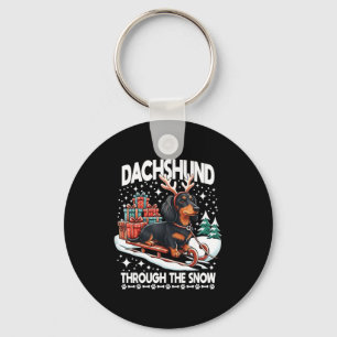 Hässlicher Dachshund Weihnachten durch den Schnee Schlüsselanhänger