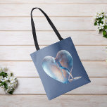 Heart Broken Blue Tote Bag<br><div class="desc">Dieses atemberaubende Design besticht durch ein Herz, das wie ein durchsichtiges Glas aussieht, das auf halbem Wege zart durchbrochen ist und das glasklare Wasser anmutig von innen fließt. Set vor einem ruhigen, blauen Hintergrund, fügt dieses einzigartige digitale Kunstwerk jedem Raum eine zeitgemäße und ätherische Touch hinzu.</div>