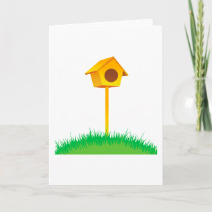 Hellgelbes Birdhouse auf Gras Karte