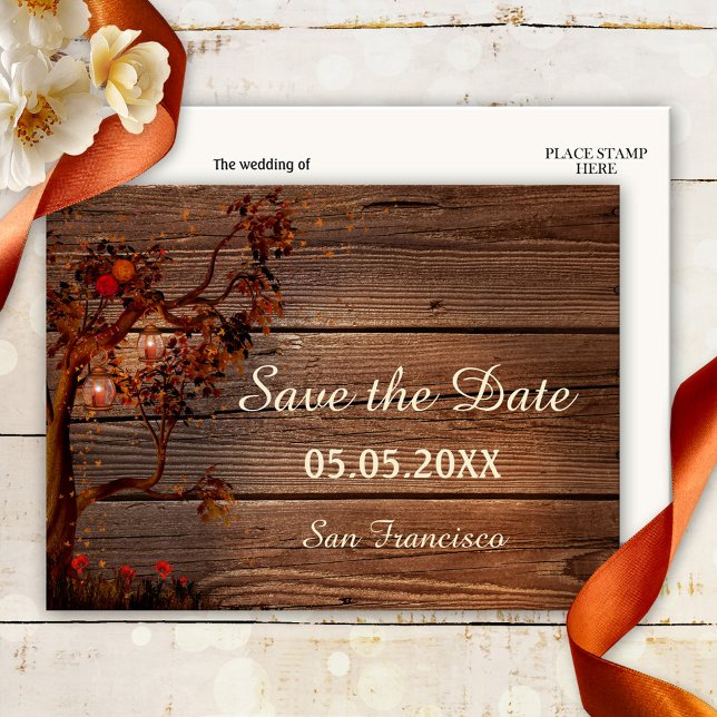 Herbstleuchten Save the Date Postkarte (Save the Date postcard featuring a tree with colorful leaves, roses and lanterns on rustic wood)