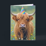 Highland Cow with Birthday Party Hat Karte<br><div class="desc">A Highland cow stands in a field of colorful wildflowers,  wearing a birthday party hat</div>