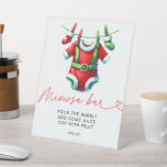 Holly Christmas Santa Baby Dusche Mimosa Bar Sockelschild<br><div class="desc">Set ein festlicher Ton mit unserem Weihnachtsdusche Mimosa Bar Sign. Mit einem fröhlichen Santa Claus-Design, umgeben von heiliger und winterlicher Vegetation, fügt dieses Schild Ihrer mimosa Bar eine Touch von Urlaubsmagie hinzu. Es eignet sich hervorragend, um die Gäste zu dieser köstlichen Getränkestation zu führen und so die Urlaubsatmosphäre Ihrer Babydusche...</div>