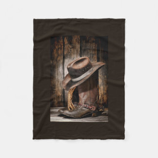 hölzerne Cowboystiefel der Westernlandbraunscheune Fleecedecke