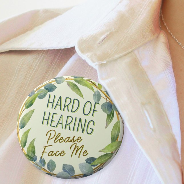 Hört mir bitte grüne Blätter zu. Button (In Situ. Badge with green leaves border and text "Hard of Hearing, Please Face Me")