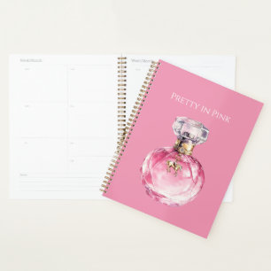 Hübsche rosa Parfümflasche mit goldenem Pferdeanhä Planer