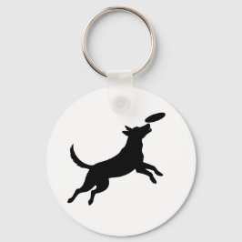 Hund springt, um eine Frisbeescheibe zu fangen Schlüsselanhänger