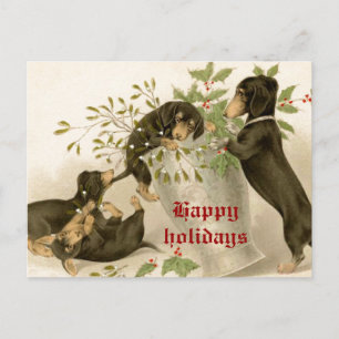 Hunde spielen mit Weihnachtsmistel und Stechpalmen Feiertagspostkarte