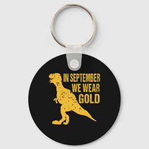 Im September tragen wir Gold Trex Childhood Cancer Schlüsselanhänger