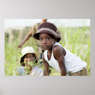 Injured child in the grass. poster