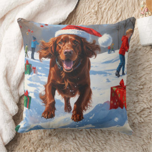 Irish Red Setter läuft durch Schnee mit Weihnachts Kissen