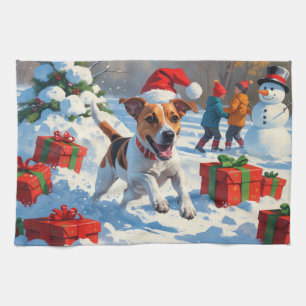 Jack Russell läuft im Schnee mit Weihnachtsmütze Geschirrtuch
